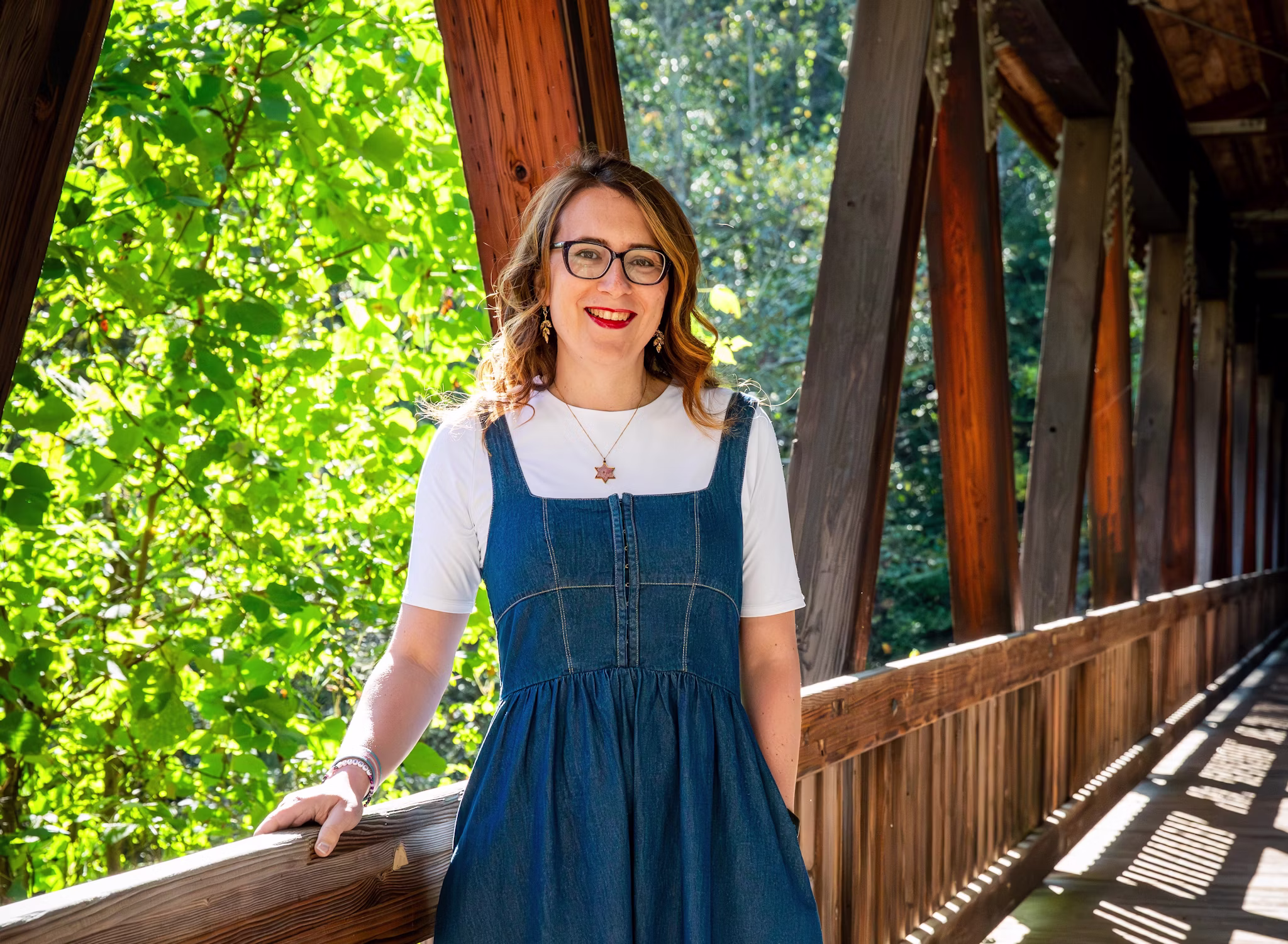 Aaron Baker standing on the covered bridge at Roswell Mill